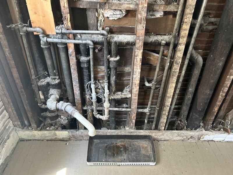 Conducted comprehensive plumbing assessment for kitchen sink relocation project and building-wide water pressure improvement. Evaluated existing plumbing infrastructure revealing severely corroded pipes with significant rust, mineral buildup, and deteriorated fittings throughout the exposed wall cavity requiring replacement. Documented conditions of aged galvanized piping system and provided detailed estimate for relocating kitchen sink fixture, replacing compromised supply lines, and upgrading water distribution system to restore adequate pressure throughout the building.