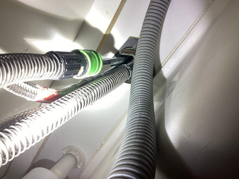 Responded to service call for leaking kitchen faucet. Upon inspection, identified leak originating from underneath faucet base at mounting area. Assessed faucet assembly and internal components to determine feasibility of rebuild versus replacement. Disassembled faucet to access supply line connections and internal cartridge mechanism. Found deteriorated O-rings and seals causing water seepage at base connection points. Successfully rebuilt faucet by replacing worn gaskets, O-rings, and internal seals. Reconnected supply lines with new compression fittings and green O-ring seals to ensure proper watertight connections. Tested faucet operation under full water pressure and verified no leaks present at base or supply connections. Faucet restored to full working condition without requiring complete replacement.