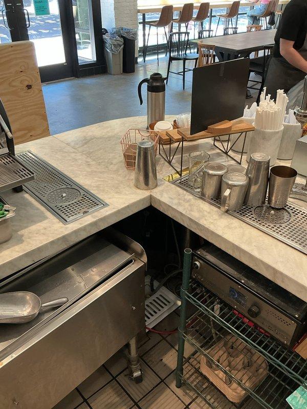 Responded to callback for commercial coffee bar plumbing system. Inspected and documented undercounter plumbing connections, drainage systems, and sink installation at beverage service station. Verified proper operation of drip tray drainage, assessed water supply lines to coffee equipment, and confirmed all plumbing fixtures were functioning correctly with no leaks or drainage issues present.