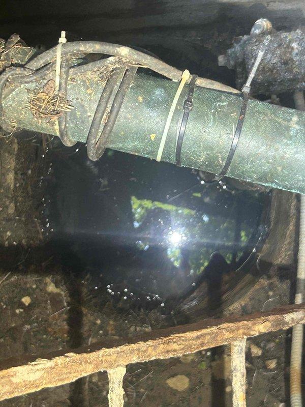 Conducted comprehensive site assessment for flood control system installation in basement/crawl space area. Evaluated existing plumbing infrastructure, including deteriorated drainage piping with visible corrosion and mineral deposits, and documented standing water conditions requiring mitigation. Provided detailed estimate for flood control system implementation to address water intrusion issues and protect property from future flooding events.