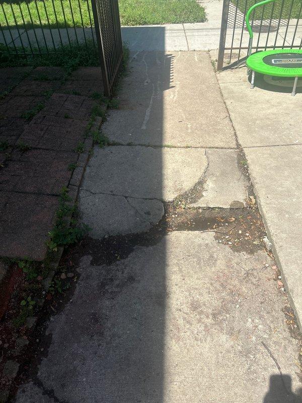 Responded to service call for suspected water leak beneath concrete slab. Conducted site assessment of exterior concrete walkway and surrounding yard area to identify potential leak sources and determine responsibility between municipal water line and residential plumbing system. Documented existing conditions including deteriorated concrete surfaces with visible cracking, discoloration, and weathering patterns that may indicate subsurface moisture issues. Evaluated property for signs of active leakage, water accumulation, or ground saturation to establish leak location and provide estimate for access and repair work.