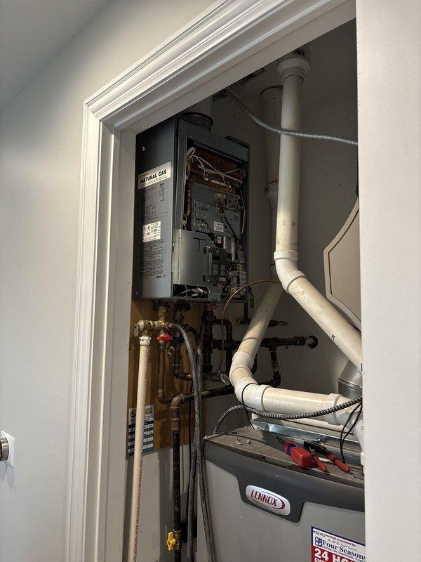 Performed complete descaling and flush service on wall-mounted tankless water heater located in utility closet. Connected circulation pump system with chemical descaling solution to inlet and outlet ports, allowing cleaning agent to flow through heat exchanger for removal of mineral buildup and scale deposits. Upon completion of flush cycle, verified unit operation and confirmed proper function of all components with no leaks detected at connection points.