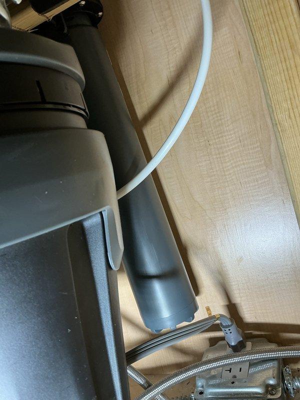 Installed Aquasana Claryum Direct Connect under-sink water filtration system on kitchen cold-water line. Mounted filter unit securely to cabinet wall in accessible location for future filter changes while maintaining clearance from pull-down faucet weight, garbage disposal unit, and trash pullout mechanism. Replaced existing shutoff valve and supply line with new components to ensure reliable connections and prevent potential leaks.