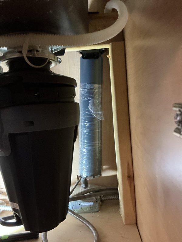 Installed Aquasana Claryum Direct Connect under-sink water filtration system on kitchen cold-water line. Mounted filter unit securely to cabinet wall in accessible location for future filter changes while maintaining clearance from pull-down faucet weight, garbage disposal unit, and trash pullout mechanism. Replaced existing shutoff valve and supply line with new components to ensure reliable connections and prevent potential leaks.