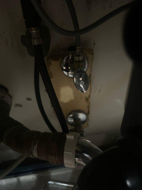 Responded to building shut down at 9AM for emergency plumbing repair. Inspected bathroom fixtures and identified issues with sink drain assembly showing significant mineral deposits and water staining around the chrome-plated drain mechanism. Examined plumbing connections beneath sink, including black flexible supply lines and white plastic drain fittings. Also assessed toilet installation and associated plumbing connections, including water supply lines and shut-off valves. Completed diagnostic evaluation and sold necessary repair services to restore proper function and address deteriorated components.