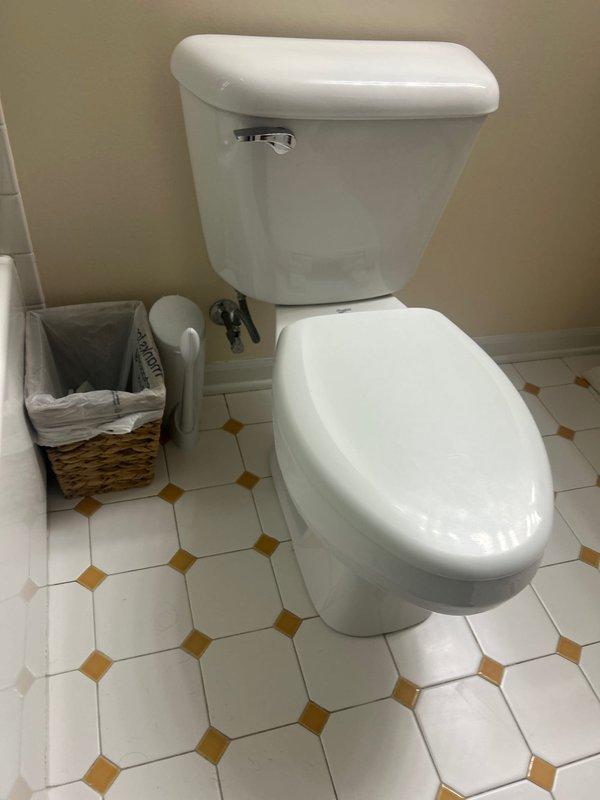 Responded to building shut down at 9AM for emergency plumbing repair. Inspected bathroom fixtures and identified issues with sink drain assembly showing significant mineral deposits and water staining around the chrome-plated drain mechanism. Examined plumbing connections beneath sink, including black flexible supply lines and white plastic drain fittings. Also assessed toilet installation and associated plumbing connections, including water supply lines and shut-off valves. Completed diagnostic evaluation and sold necessary repair services to restore proper function and address deteriorated components.