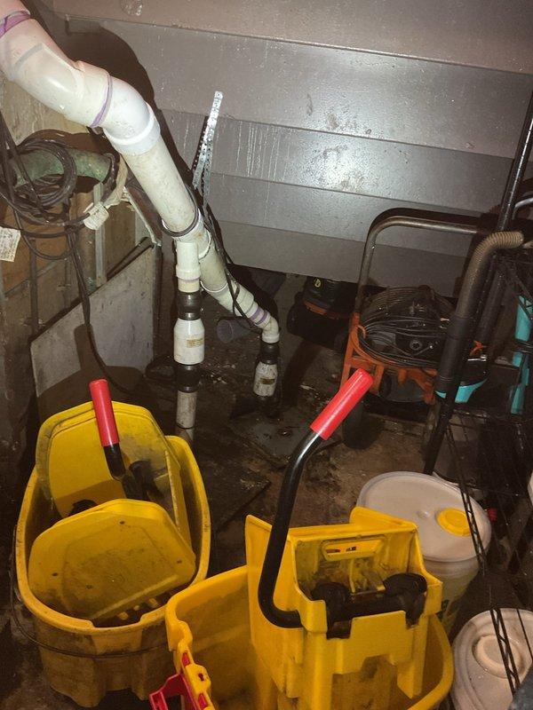 Responded to commercial plumbing service call for employee bathroom floor drain backup and annual maintenance scheduling. Upon arrival, accessed basement utility area and assessed drainage system infrastructure. Deployed wet/dry vacuum equipment and specialized drain cleaning tools to address the backing up floor drain. Inspected exposed PVC drainage pipes and connections for blockages, damage, or deterioration. Cleared obstruction from floor drain line to restore proper drainage flow. Evaluated overall plumbing system condition including vertical drain stacks, pipe connections, and basement utility area components in preparation for coordinating scheduled yearly maintenance visit at time suitable for business operations starting at 11 am.