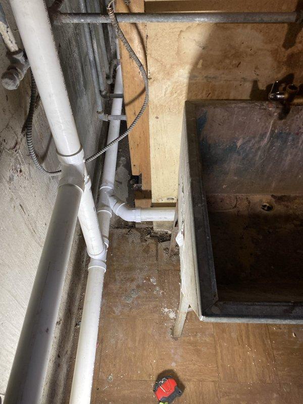 Completed residential drain and sewer estimate for utility room plumbing installation. Assessed existing condensate pump system, laundry drainage configuration, and PVC waste line routing in basement area. Documented current plumbing layout including vertical and horizontal drain pipes with cleanout access points. Customer to contact for vanity installation scheduling to finalize project scope.