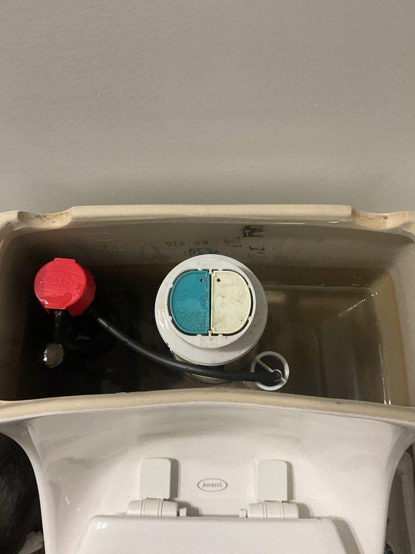 Responded to service call for low water pressure affecting toilet fill operation following previous water main repair work. Upon inspection, found Glacier Bay dual-flush toilet with insufficient tank refill despite adequate household water pressure. Examined internal tank components including fill valve assembly, flush valve mechanism, and supply line connections. Identified restricted flow through fill valve, likely due to debris accumulation from previous main line break and repair activities. Adjusted fill valve settings and cleared obstruction from valve inlet screen. Tested flush cycle multiple times to verify proper tank refill and water level restoration. Documented existing tank components and water quality conditions with photographs for service records.
