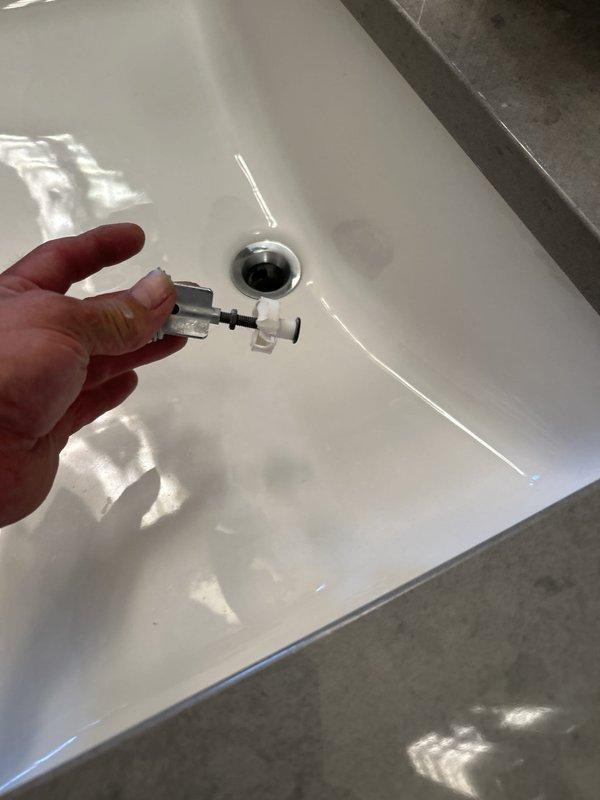 Responded to service call for toilet noise issue and shower leak. Diagnosed and resolved thump noise occurring during toilet flush cycle. Addressed leaking shower nozzle that had become loose and was causing water discharge from side of shower assembly. Replaced drain stopper mechanism and pop-up assembly in sink basin. All plumbing fixtures tested and verified operational upon completion.