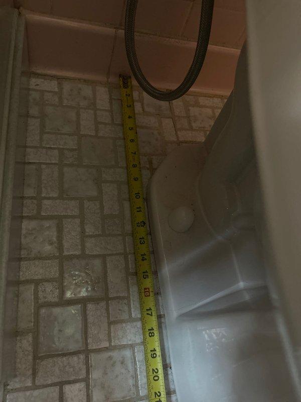 Completed toilet installation in residential bathroom with accessibility features. Verified 17-inch rough-in measurement and coordinated parts procurement prior to installation. Installed toilet fixture with surrounding grab bars for ADA compliance, ensuring proper positioning and secure mounting on existing tile flooring with herringbone pattern.
