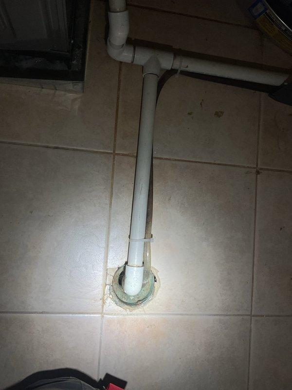 Responded to a main drain backup affecting the floor drain receiving discharge from the HVAC system's air conditioning and humidifier condensate lines. Upon arrival, accessed the utility room where the mechanical equipment is located and identified the problematic floor drain with the vertical PVC drainage pipe. Cleared the backed-up floor drain to restore proper drainage function for the HVAC condensate system. The floor drain is now flowing freely and accepting water from the air conditioning and humidifier units without obstruction.