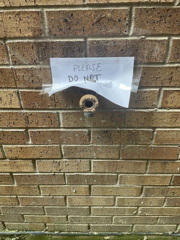 Responded to priority service call for outdoor spigot leaking into ceiling above basement area. Upon inspection, identified failed spigot connection at exterior brick wall causing water to spray behind wall when activated. Replaced defective hose bib with new brass spigot, ensuring proper seal and weatherproofing at wall penetration. Tested system under full pressure to verify repair eliminated interior water intrusion. Placed temporary signage on exterior spigot advising against use during repair process. Confirmed no active leaking in basement ceiling following installation and pressure testing.