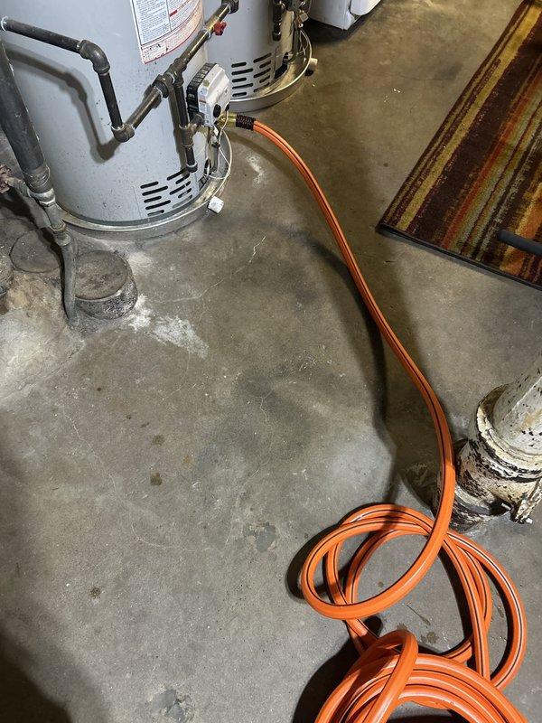 Responded to service call for leaking kitchen sink sprayer on second floor of century-old home where leak had been ongoing for two weeks. Inspected kitchen sink assembly, identified faulty sprayer head and hose connection causing water intrusion. Replaced defective sprayer unit and verified all connections for proper seal. Additionally performed requested maintenance inspection on hot water tank system located in basement utility area, checking temperature and pressure relief valve operation, examining anode rod condition, flushing sediment from tank, and inspecting all water and gas connections for safety and proper function. All systems tested and confirmed operational upon completion.