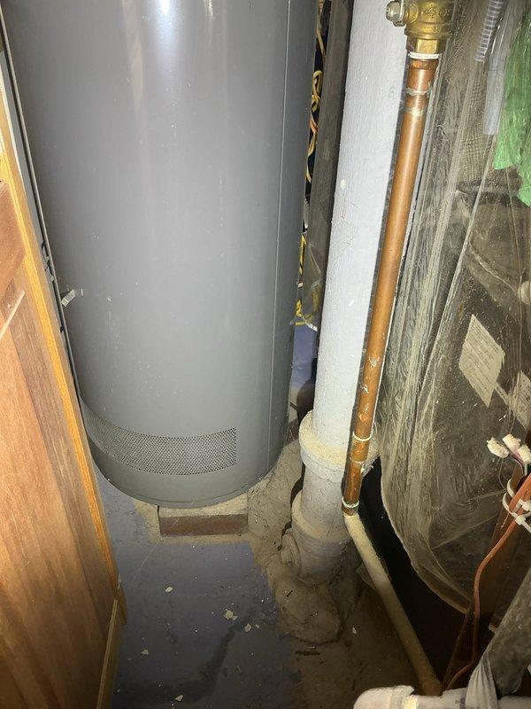 Conducted a comprehensive drain and sewer estimate for a residential property, evaluating both the basement utility area and bathroom plumbing systems. Documented existing conditions including water heater installation, copper supply lines with brass fittings, aging storage tank with visible deterioration, and PVC drainage components in the mechanical room. Assessed bathroom fixtures including bathtub drain assembly, chrome plumbing fixtures, and tile surrounds to determine scope of potential sewer line work and drainage system improvements needed for the property.