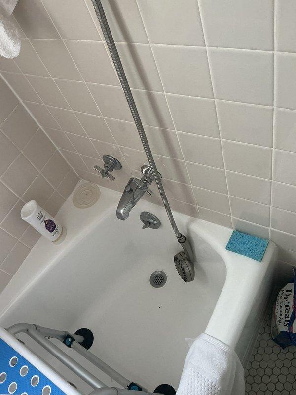 Conducted a comprehensive drain and sewer estimate for a residential property, evaluating both the basement utility area and bathroom plumbing systems. Documented existing conditions including water heater installation, copper supply lines with brass fittings, aging storage tank with visible deterioration, and PVC drainage components in the mechanical room. Assessed bathroom fixtures including bathtub drain assembly, chrome plumbing fixtures, and tile surrounds to determine scope of potential sewer line work and drainage system improvements needed for the property.
