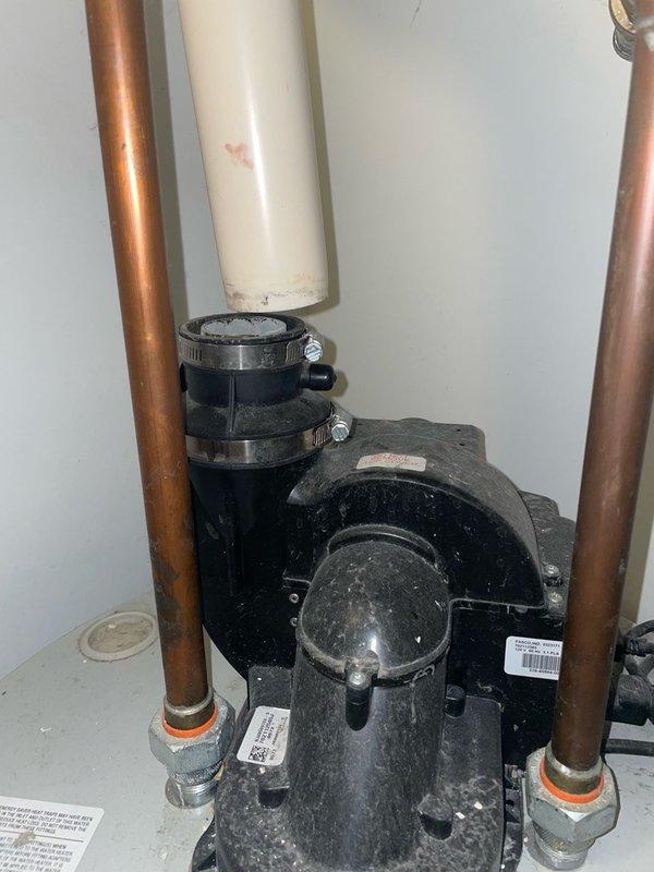Responded to emergency service call for disconnected exhaust vent pipe on tanked water heater in utility closet. Upon arrival, confirmed that the white PVC exhaust vent pipe had separated from the rubber coupling connection at the ceiling overnight, causing a loud noise that prompted the occupant to shut off the electrical breaker and gas supply as a safety precaution. 

Inspected the exhaust vent assembly and identified that the rubber coupling with metal hose clamps had failed, allowing the vertical PVC pipe to disconnect from the water heater's exhaust system. Verified no water leaks or damage to surrounding areas. Cleaned accumulated dirt and debris from the pipe connection points and coupling surfaces to ensure proper seal. Reinstalled the exhaust vent pipe into the rubber coupling adapter, ensuring proper alignment and secure fit. Tightened metal hose clamps on both sections of the coupling to manufacturer specifications to prevent future disconnection.

Restored gas supply and e