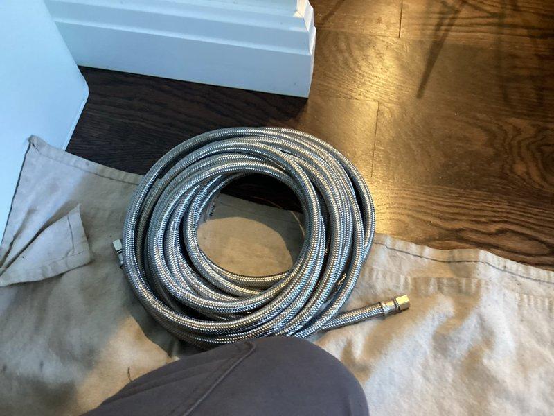 Responded to warranty callback for leaking ice maker supply line following recent water line repair. Upon inspection, discovered frost accumulation on copper refrigerator water line indicating active leak and temperature differential. Replaced defective braided stainless steel supply line with new connection, ensuring proper fitting installation and seal integrity. Verified all connections leak-free and system operational upon completion.