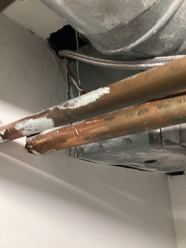 Responded to warranty callback for leaking ice maker supply line following recent water line repair. Upon inspection, discovered frost accumulation on copper refrigerator water line indicating active leak and temperature differential. Replaced defective braided stainless steel supply line with new connection, ensuring proper fitting installation and seal integrity. Verified all connections leak-free and system operational upon completion.