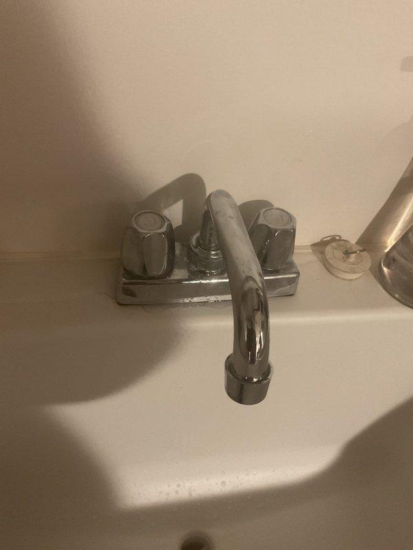 Responded to service call for bathroom faucet handle that would not turn off properly and leaking toilet. Inspected the three-piece brushed brass faucet assembly on undermount sink and identified worn valve cartridge preventing proper shutoff. Replaced faulty cartridge and tested operation of both handles to ensure proper water flow control. Diagnosed toilet leak, identified failed wax ring seal at base, and replaced wax ring to eliminate water seepage. Verified all fixtures functioning properly with no active leaks upon completion.