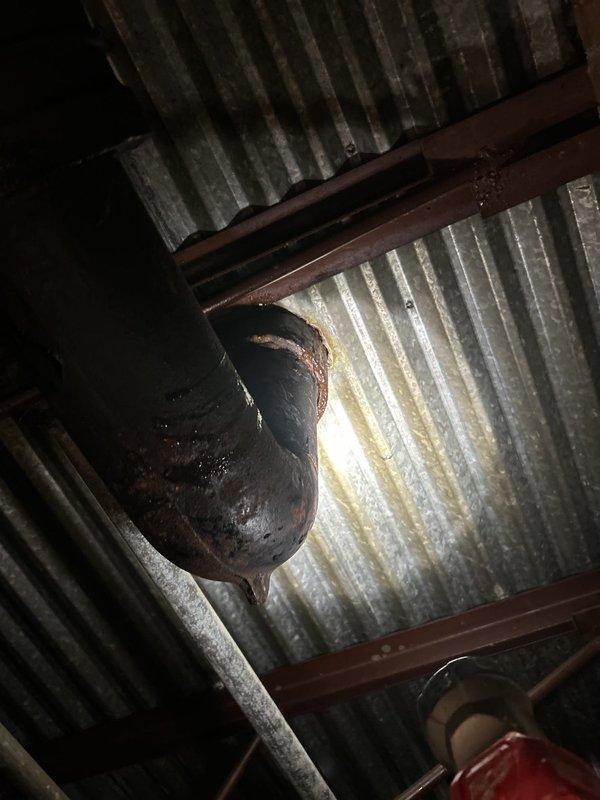 Responded to commercial facility for reported toilet leaking at base. Upon inspection, identified failed wax ring seal and corroded closet flange causing water seepage around toilet base. Removed toilet, replaced deteriorated wax ring and corroded mounting hardware, reinstalled unit, and verified proper seal with no active leaks.