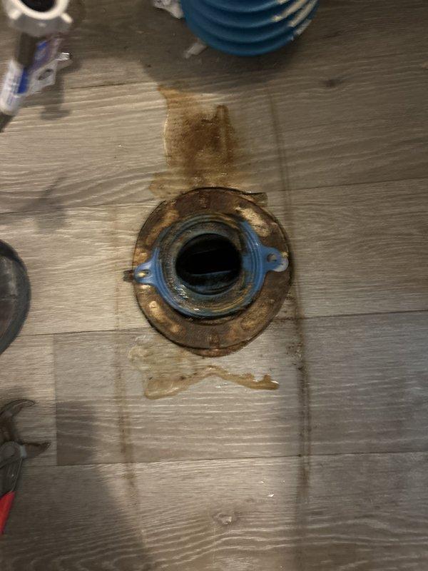 Responded to commercial facility for reported toilet leaking at base. Upon inspection, identified failed wax ring seal and corroded closet flange causing water seepage around toilet base. Removed toilet, replaced deteriorated wax ring and corroded mounting hardware, reinstalled unit, and verified proper seal with no active leaks.