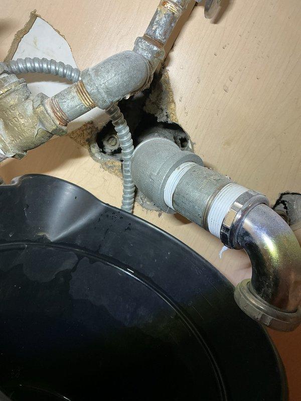 Responded to emergency plumbing situation where corroded and burst pipes under kitchen sink required complete replacement. Removed deteriorated galvanized piping showing significant corrosion and wall damage, then installed new plumbing connections to restore water service to commercial-grade stainless steel sink basin. Documented existing conditions including mold damage around wall penetrations and assessed structural integrity of remaining plumbing infrastructure before completing repairs.