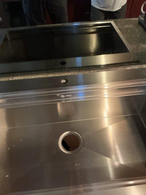 Responded to emergency plumbing situation where corroded and burst pipes under kitchen sink required complete replacement. Removed deteriorated galvanized piping showing significant corrosion and wall damage, then installed new plumbing connections to restore water service to commercial-grade stainless steel sink basin. Documented existing conditions including mold damage around wall penetrations and assessed structural integrity of remaining plumbing infrastructure before completing repairs.