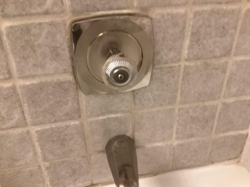 Replaced worn Moen cartridge in bathroom shower fixture to restore proper water flow and temperature control. Verified operation of shower valve assembly and ensured chrome trim components were properly seated against tile wall upon completion.