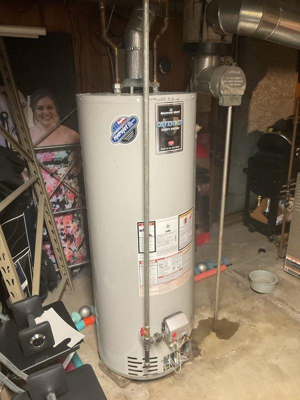 Inspected existing Bradford White water heater with Defender Safety System installed in 2016. Evaluated current condition of unit, copper piping connections, venting system, and associated plumbing infrastructure. Documented water heater specifications, safety labels, and overall installation configuration. Photographed unit and surrounding utility area for service records. Sold repair services to address water heater maintenance or replacement needs identified during inspection.