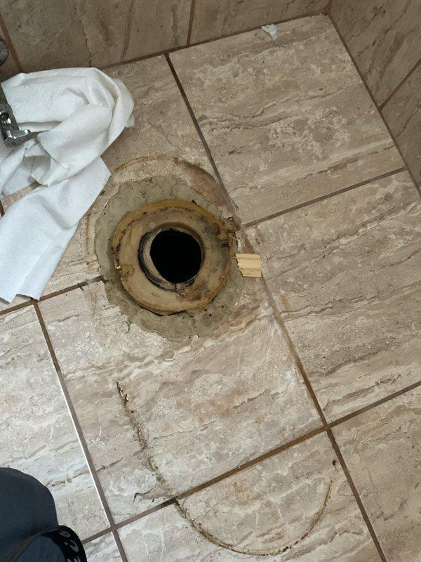 Responded to report of water leak in main floor half bathroom with visible water ring on basement ceiling below toilet. Upon inspection, removed toilet to access flange and wax ring seal. Confirmed failed wax ring as source of leak, with evidence of water intrusion around toilet base and flange area. Cleaned and prepped flange, installed new wax ring seal, reset toilet with proper alignment and secure bolting, and tested for leaks to verify repair completion.