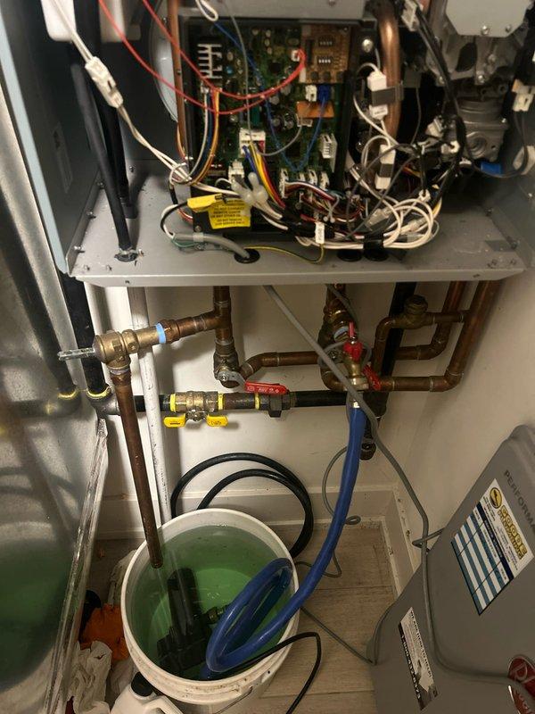 Responded to service call for leaking toilet and tankless water heater maintenance. Inspected toilet installation and identified source of water leak at base connection. Performed comprehensive maintenance on tankless water heater system, including inspection of internal circuit board, capacitors, and electronic control components. Checked all copper plumbing connections, shut-off valves with red handles, and yellow-handled gas valve for proper operation and potential leaks. Flushed system using descaling solution to remove mineral buildup from heat exchanger. Verified proper function of all electrical connections including red, white, blue, brown, and yellow wiring to control board. Tested temperature output and flow rate to ensure unit operates within manufacturer specifications. Addressed toilet leak and confirmed proper seal and water flow. All systems tested and operational upon completion.