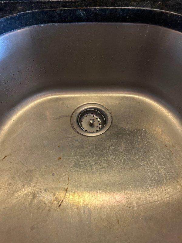 Responded to kitchen sink leak complaint. Inspected under-sink plumbing assembly including P-trap, tailpiece, and water supply connections. Examined chrome-plated drain assembly, shut-off valves with flexible supply lines, and all connection points for signs of moisture or active leaking. Documented existing plumbing configuration and condition of fixtures. All components photographed for assessment and estimate preparation.