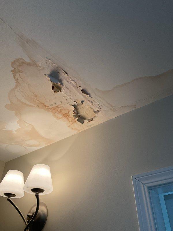 Responded to report of water leak causing damage to first floor ceiling, with customer suspecting furnace water line as source. Upon inspection, identified extensive water damage to ceiling with significant staining, discoloration, and material deterioration in multiple areas. Documented existing damage showing brown and tan water stains with irregular patterns indicating prolonged moisture infiltration from above. Examined ceiling cavity through deteriorated sections and assessed visible crack/seam running diagonally across affected area. Investigated potential source points including furnace water line connection as reported. Captured photographic documentation of damaged ceiling sections and overall affected areas for record and estimate purposes. Recommended further investigation of upper level plumbing connections and furnace humidifier line to pinpoint exact leak source before proceeding with repairs.