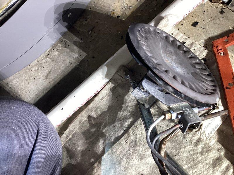 Responded to service call for HVAC equipment assessment on rooftop installation. Upon arrival, inspected motor assembly and fan components showing signs of operational wear and requiring maintenance attention. Documented existing conditions including motor housing, mounting hardware, and ventilation system components positioned on concrete pad. Evaluated structural mounting brackets, securing hardware, and overall equipment stability to ensure proper operational safety standards. Photographed equipment configuration and component layout for service records and future reference.
