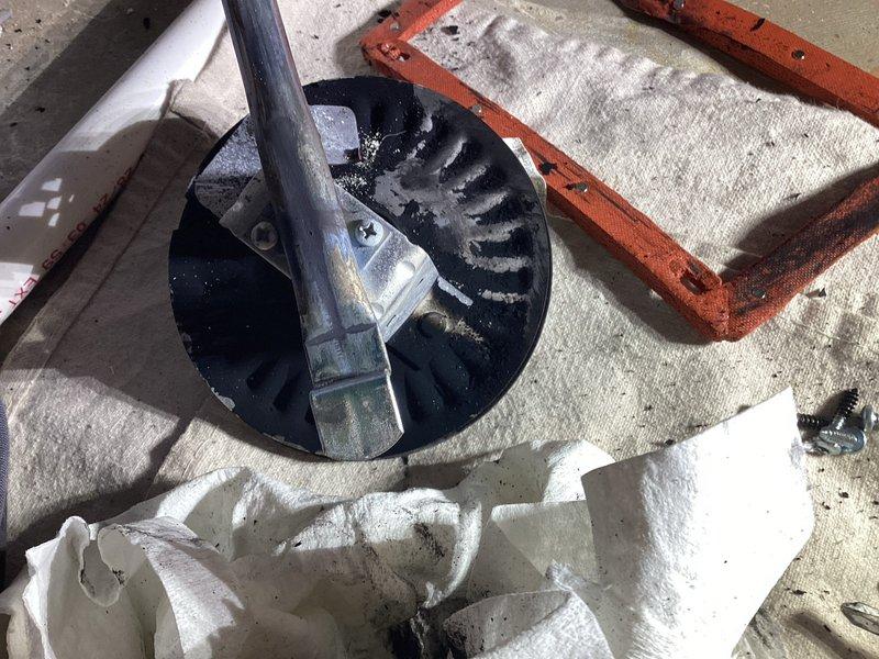 Responded to service call for HVAC equipment assessment on rooftop installation. Upon arrival, inspected motor assembly and fan components showing signs of operational wear and requiring maintenance attention. Documented existing conditions including motor housing, mounting hardware, and ventilation system components positioned on concrete pad. Evaluated structural mounting brackets, securing hardware, and overall equipment stability to ensure proper operational safety standards. Photographed equipment configuration and component layout for service records and future reference.
