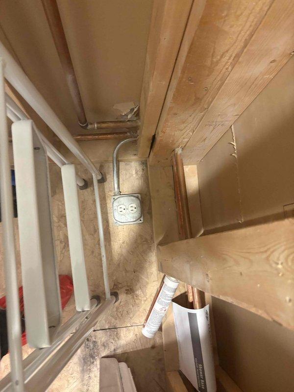 Completed plumbing reconfiguration for bathroom remodel involving relocation of supply and drain lines to accommodate new shower and vanity dimensions. Exposed existing wall cavities, rerouted PEX water supply lines and copper piping, installed necessary valves and connections, and prepared rough-in plumbing to meet updated fixture placements per remodel specifications.