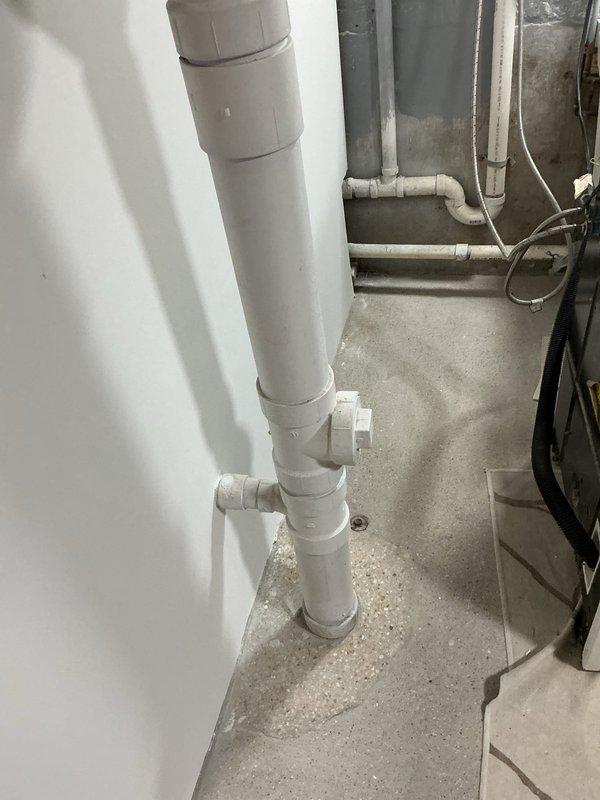 Responded to customer complaint of sewage odor in bathrooms. Previous technician had ruled out toilet as source and confirmed proper wax ring seal. Inspected basement plumbing infrastructure and drainage system to identify odor source. Confirmed shower drain lacks proper P-trap installation, allowing sewer gases to enter living space through drain line. Documented existing PVC drainage configuration and photographed plumbing layout for reference. Reviewed multiple remediation options with customer including P-trap installation methods, venting requirements, and code compliance considerations to permanently eliminate odor issue.