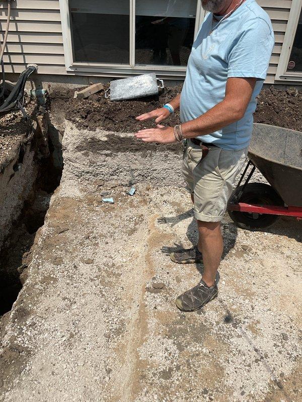 Conducted site assessment for gas line installation to serve outdoor grill in side yard location. Evaluated existing gas meter placement, determined optimal routing path through narrow passageway between structures, and assessed concrete paver walkway and landscaping considerations for trenching and pipe installation. Provided estimate for materials and labor required to run new gas piping from meter to grill connection point on rear patio area.