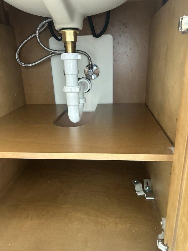 Collected final payment for previously installed sump pump system. Completed installation of bathroom vanities with plumbing connections, including P-trap assembly, supply line hookups, and shut-off valve installation. One vanity remains to be installed pending technician return visit to complete the project per customer request.