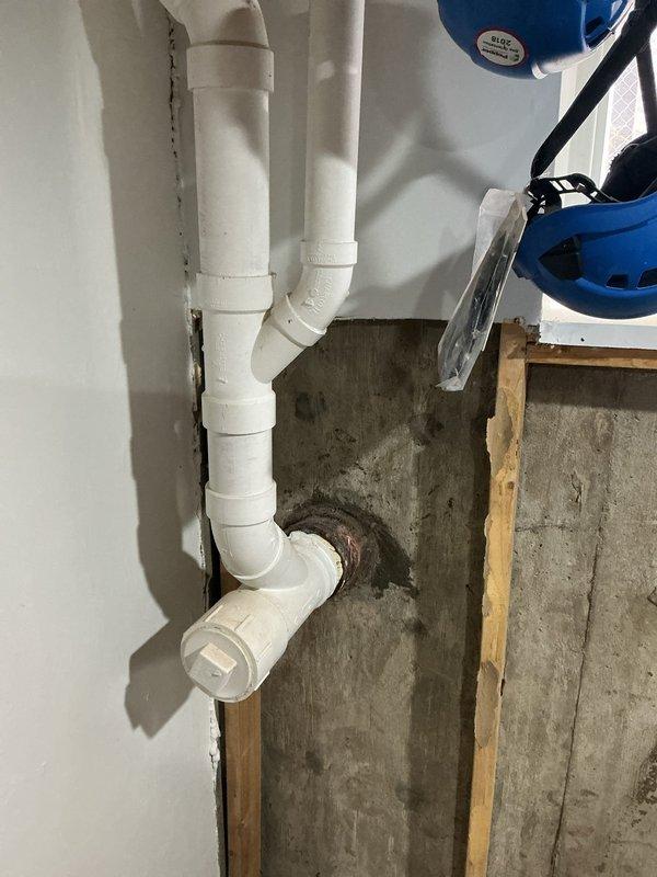 Responded to a cracked sewer line located immediately outside the foundation where the main drain exits the building. Excavated adjacent to the foundation wall to expose the damaged section of pipe, then repaired the compromised segment using PVC pipe and fittings per customer's request for repair rather than full line replacement. Backfilled excavation upon completion of repairs and tested system for proper drainage function.