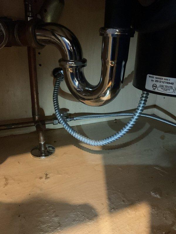 Responded to a low water pressure issue affecting dishwasher operation. Upon inspection of the under-sink plumbing, examined the water supply lines, shutoff valves, and connection points serving the dishwasher. Assessed the braided stainless steel supply lines and verified proper flow from the main supply valves. Checked for debris, sediment buildup, or partial valve closure that could restrict water flow to the dishwasher inlet. Documented existing plumbing configuration including P-trap assembly, garbage disposal unit, and supply line routing for reference.
