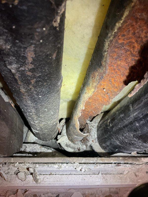 Completed plumbing repair involving severely corroded water supply lines accessed through wall cavity. Removed section of drywall to expose deteriorated pipes showing extensive rust and corrosion, replaced compromised piping sections with new materials, and sealed wall opening upon completion of repairs.
