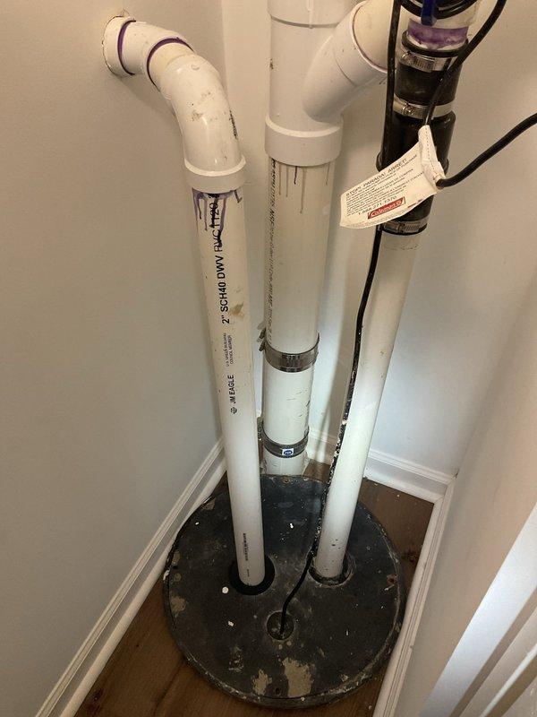 Completed comprehensive inspection and maintenance assessment of two basement sump pump systems in recently purchased residential property. Primary concern addressed involved improper sealing on one unit causing sewer gas odors to enter the basement during shower usage. Upon inspection, identified severely corroded sump basin with deteriorated components and compromised float mechanism submerged in standing water. Evaluated existing water treatment system including PVC discharge piping, check valves, and filtration components for proper operation and code compliance. Provided estimate for necessary repairs including basin replacement, proper venting installation to eliminate odor issues, and battery backup system installation as existing pumps lacked emergency power protection.