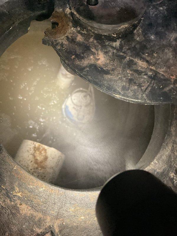 Completed comprehensive inspection and maintenance assessment of two basement sump pump systems in recently purchased residential property. Primary concern addressed involved improper sealing on one unit causing sewer gas odors to enter the basement during shower usage. Upon inspection, identified severely corroded sump basin with deteriorated components and compromised float mechanism submerged in standing water. Evaluated existing water treatment system including PVC discharge piping, check valves, and filtration components for proper operation and code compliance. Provided estimate for necessary repairs including basin replacement, proper venting installation to eliminate odor issues, and battery backup system installation as existing pumps lacked emergency power protection.