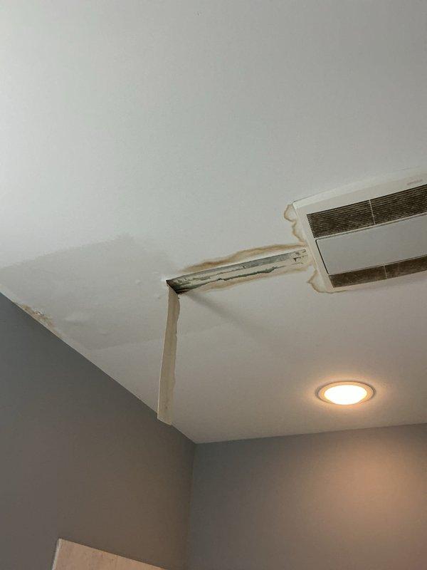 Responded to priority service call for water damage investigation with visible ceiling staining below kitchen plumbing. Upon inspection, identified active leak from kitchen sink drain assembly and P-trap connections causing water intrusion to ceiling below. Tightened all trap connections, replaced deteriorated tailpiece gasket, and verified garbage disposal drain connections for proper seal. Tested all fixtures under full water flow to confirm leak resolution and advised monitoring ceiling stain for drying over next several days.