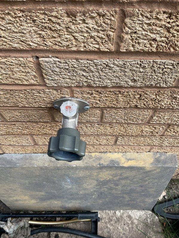Replaced deteriorated exterior hose bib and mounting block on brick wall. The original water spigot showed significant weathering and the mounting surface had deteriorated, requiring removal and installation of new fixture with proper sealing to prevent water intrusion into the wall structure.