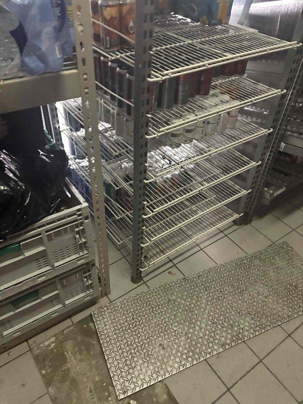 Conducted on-site plumbing estimate for commercial kitchen piping requirements. Assessed existing infrastructure and photographed storage area containing wire shelving units to document current conditions and determine piping routing options. Evaluated floor layout, including diamond-plate matting placement, and identified potential pathways for new plumbing lines while considering existing ductwork and equipment placement to ensure proper installation access and code compliance.