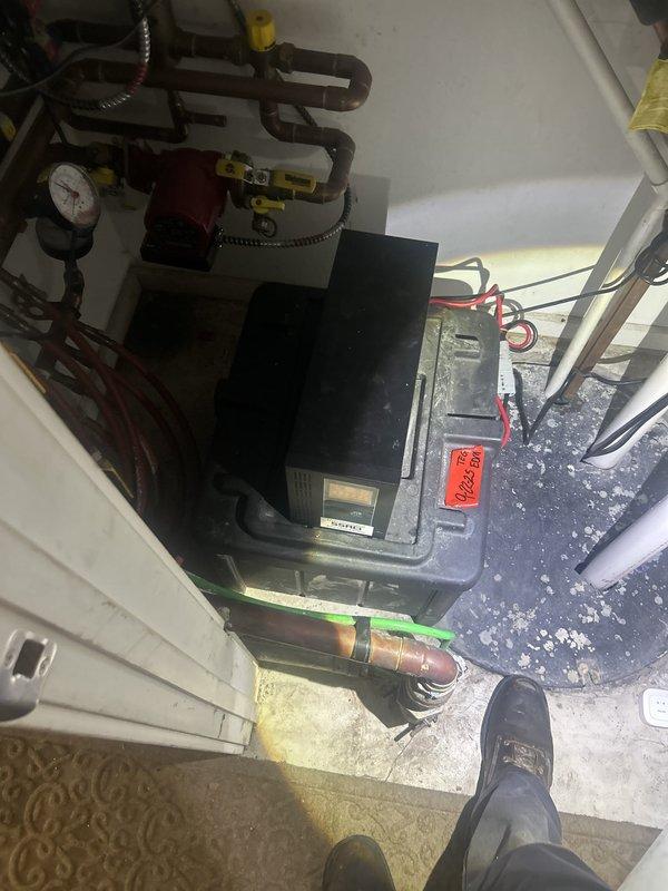 Responded to water leak reported in basement closet ceiling with water accumulation in light fixture. Upon arrival, inspected mechanical room housing heating/boiler system with associated piping network. Cut access opening in ceiling to investigate source of leak. Inspection revealed gray PVC piping running through ceiling joists with evidence of moisture damage and staining on surrounding surfaces. Traced leak to compromised plumbing connection in vicinity of mechanical equipment. Documented conditions with photographs showing mechanical system, pressure gauge, valve assemblies, and ceiling cavity access point. Identified leak source and provided assessment for necessary repairs to prevent further water intrusion and damage to electrical fixtures below.