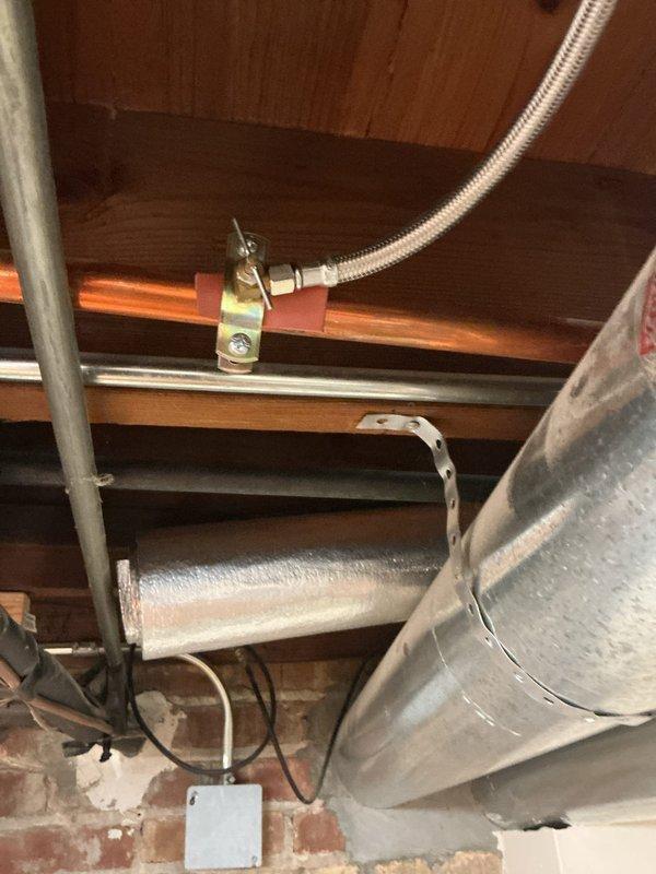 Replaced outdated ice maker saddle valve with a code-compliant quarter-turn shut off valve on 3/4" copper water supply line. The new valve installation provides reliable water control and eliminates potential leak points associated with the old saddle valve configuration.